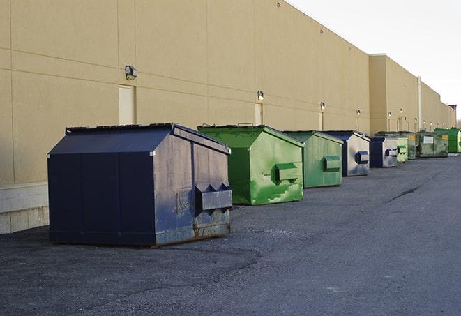 a crowd of dumpsters of all colors and sizes at a construction site in Beach Park